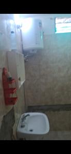 a bathroom with a white sink in a stall at Francolini dptos in La Banda