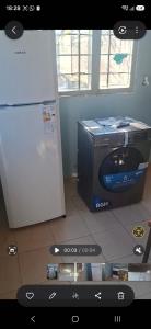 a kitchen with a refrigerator and a microwave at Francolini dptos in La Banda