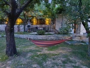 a hammock hanging from a tree in a yard at Pergola Garden in Nikšić