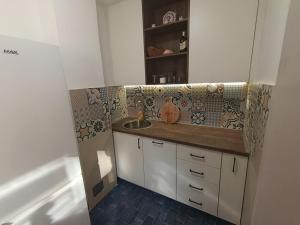 a kitchen with a sink and a counter with tiles at Pergola Garden in Nikšić