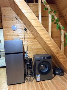 a refrigerator and a washing machine in a room at ჰარმონია Harmony Cottage in Ambrolauri