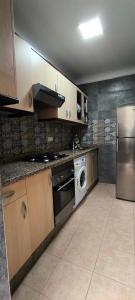 a kitchen with a washer and dryer in it at kabila vista Z1 2 chambres in M'diq