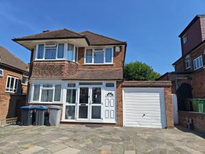 a brick house with a white garage at Standard Double Room with Shared Bathroom in London