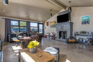 a living room with leather furniture and a fireplace at Hraunborgir Golden Circle Tents in Kiðjaberg