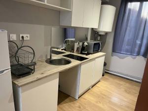 a small kitchen with a sink and a microwave at studio in Saint-Pourçain-sur-Sioule