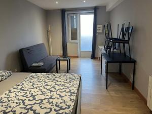 a room with a bed and a couch and a table at studio in Saint-Pourçain-sur-Sioule