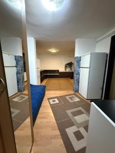 an empty room with a refrigerator and a couch at Loret in Kragujevac
