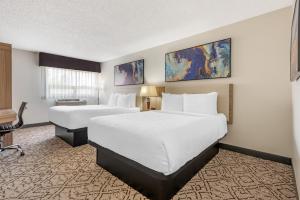 a hotel room with two beds and a desk at Best Western Airport Inn in Calgary +22 photos