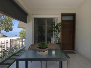 a table on the balcony of a house at Kýma Seafront House in Patra