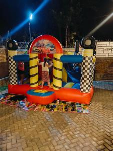 a girl is playing on an inflatable playground at Mansarda Park View Hotel in Nyagatare