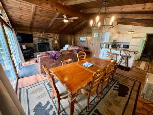a dining room and living room with a wooden table at Cabin on the hill Ascutney in Jenneville