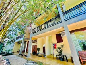 a large building with trees in front of it at Villa Rustic in Negombo