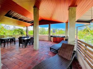 a patio with a table and chairs on a porch at Villa Rustic in Negombo