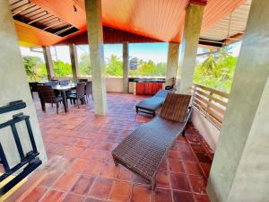 a patio with chairs and a table on a porch at Villa Rustic in Negombo +15 photos