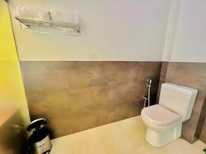 a bathroom with a white toilet in a room at Villa Rustic in Negombo