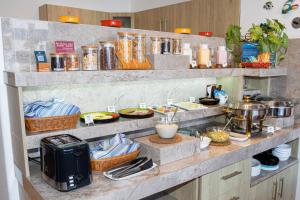 a kitchen with a counter with food on it at Hotel Cucuve in Puerto Ayora