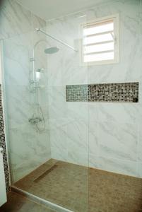 a bathroom with a shower with a glass door at Villa Domi in Antsiranana +9 photos