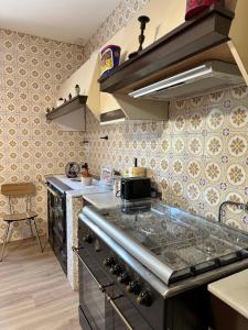 a kitchen with a stove top oven in a kitchen at Casiña Carreiro in Beade