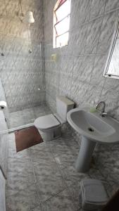 a bathroom with a toilet and a sink and a shower at Pousada Iasbeck in Santa Rita de Jacutinga +23 photos
