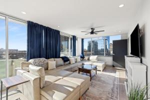 a living room with a couch and a large window at 175 LEX - Walkable Downtown Lexington & Rupp Arena - Full Condos in Lexington