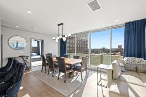 a living room with a table and chairs and a large window at 175 LEX - Walkable Downtown Lexington & Rupp Arena - Full Condos in Lexington