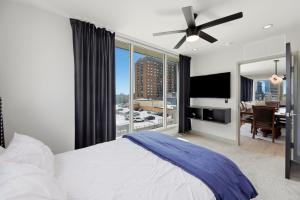 a bedroom with a large bed and a large window at 175 LEX - Walkable Downtown Lexington & Rupp Arena - Full Condos in Lexington