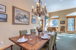 a dining room with a wooden table and chairs at Gore Creek Alpine Chalet in Vail