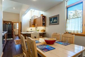 a kitchen and dining room with a wooden table and chairs at Gore Creek Alpine Chalet in Vail