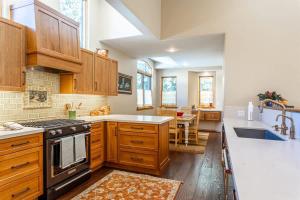 a kitchen with wooden cabinets and a stove top oven at Gore Creek Alpine Chalet in Vail