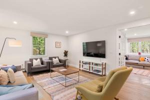 a living room filled with furniture and a flat screen tv at Spacious Home with Private In-Ground Pool in Brewster