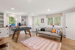 a living room with a couch and a table at Spacious Home with Private In-Ground Pool in Brewster