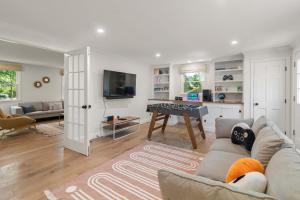 a living room with a couch and a table at Spacious Home with Private In-Ground Pool in Brewster +35 photos