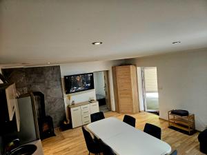 a living room with a white table and a fireplace at Apartament Martiany 1 in Kętrzyn