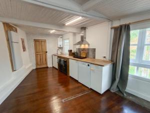 a kitchen with a wooden floor and a counter top at A Casiña do Río in Celanova