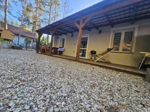 a house with a large pile of rocks in front of it at Apartament Martiany 1 in Kętrzyn