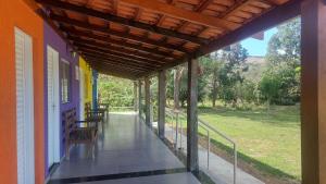 a porch of a house with a bench on it at Cachoeiras Pé da Serra in São João Batista do Glória