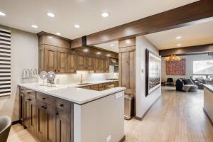 a kitchen with wooden cabinets and a white counter top at Vail Ski-In Ski-Out Chalet in Vail