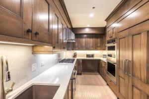 a kitchen with wooden cabinets and a counter top at Vail Ski-In Ski-Out Chalet in Vail