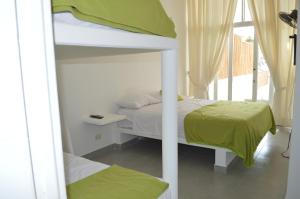 a bedroom with two bunk beds and a window at Villa Vichayito Relax in Vichayito