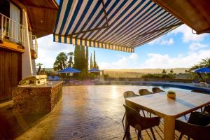a patio with a table and chairs and a pool at Via Vallarta in Los Angeles