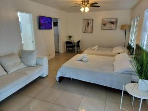 a bedroom with two beds and a couch at Comfortable Large Studio-J in Hollywood