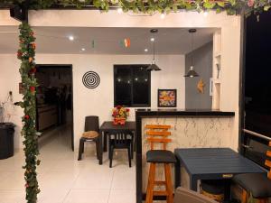 a kitchen with a bar and a table and chairs at Apart Hotel miwi in Los Patios
