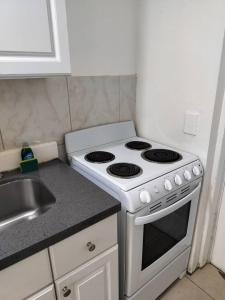 a kitchen with a white stove and a sink at Comfortable Large Studio-J in Hollywood