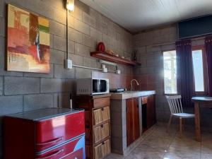 a kitchen with a red refrigerator and a microwave at Nelumbo Petit Chalet in San Rafael