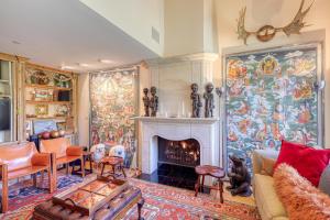 a living room with a fireplace and a large painting at Ski-in Ski-Out the View in Vail in Vail