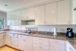 a kitchen with white cabinets and a sink at Ski-in Ski-Out the View in Vail in Vail +14 photos