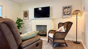 a living room with a couch and a fireplace at Sabana in Lake Charles