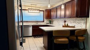 a kitchen with wooden cabinets and a counter top at Sabana in Lake Charles