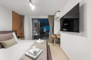 a hotel room with a bed and a flat screen tv at Villa Olea Mandalina in Šibenik