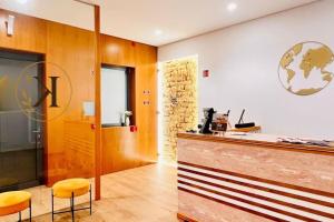 a restaurant with a counter and two stools at Kariokas Hospedagem in Águeda +22 photos